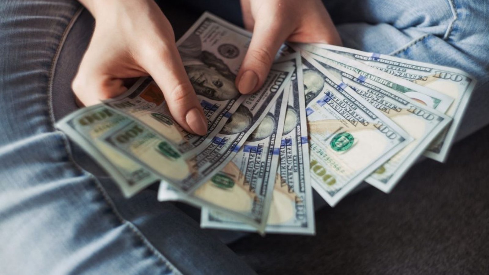 woman holding us dollars